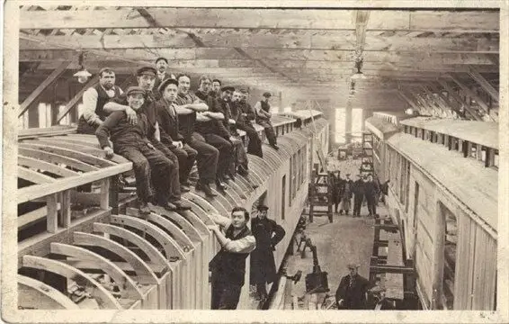 Image of men working on rail cars